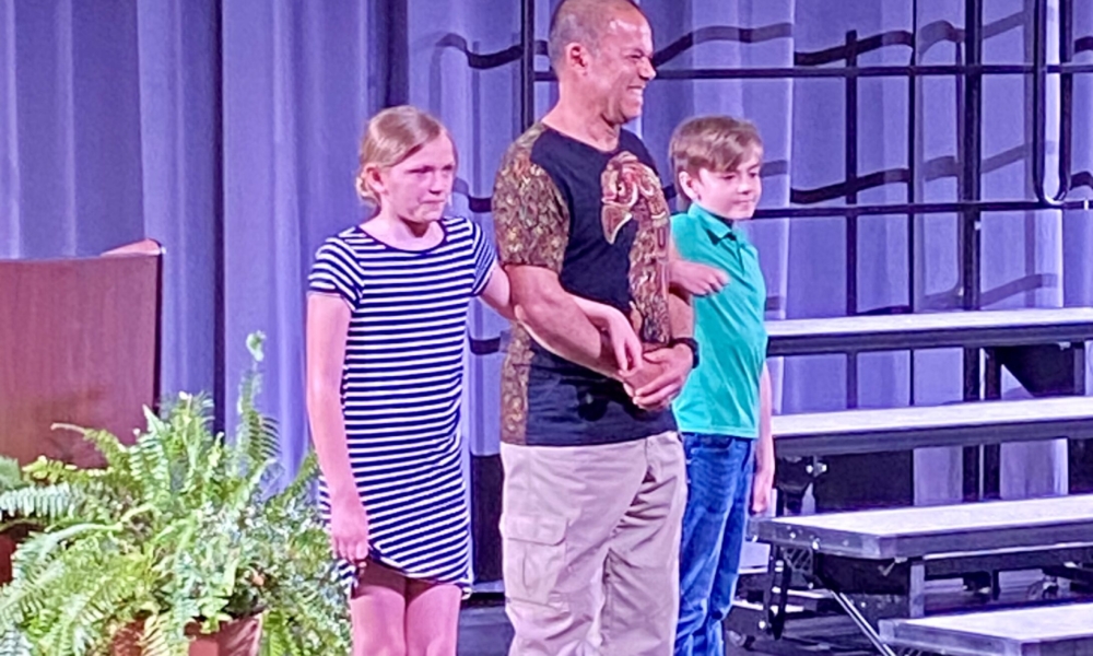 Students_Escort_Elder_up_on_Stage